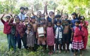 Photo of children cheering. 